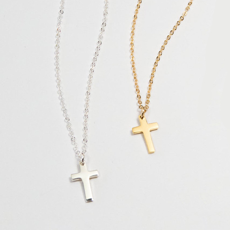 Mini Sterling Silver Cross Charm Necklace Mini sterling silver cross charm necklace on a fine chain