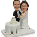 Cake-Cutting Couple Figurine Couple figurine cutting a cake