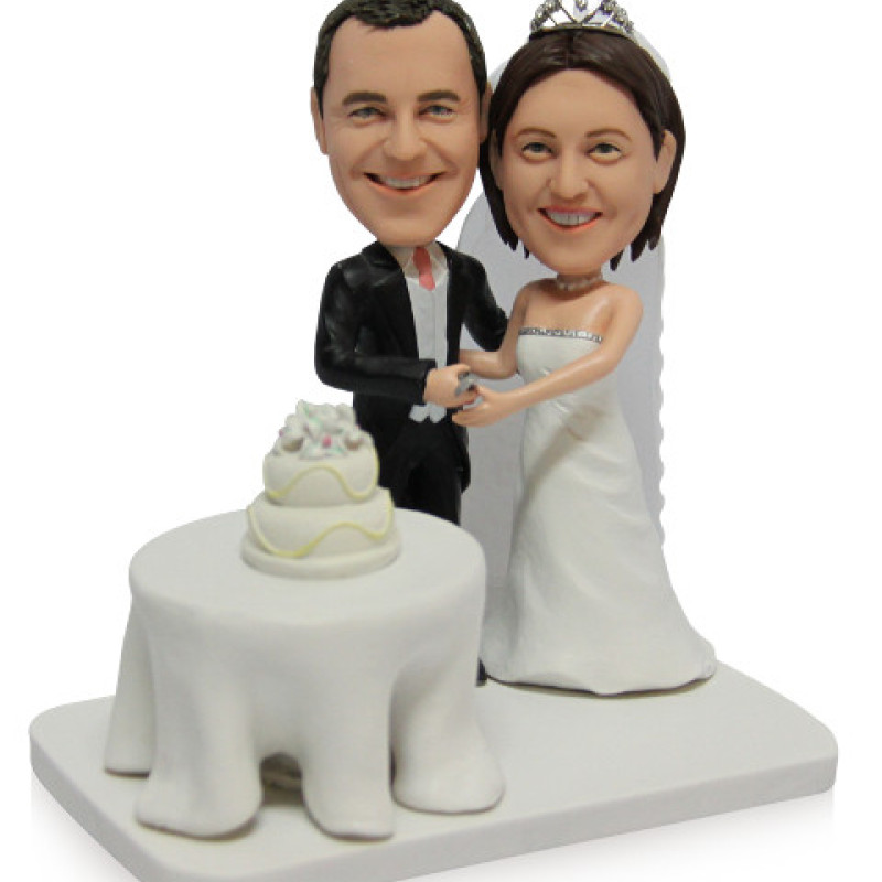 Cake-Cutting Couple Figurine Couple figurine cutting a cake