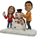 Snowman Couple Figurine Couple figurine with snowman background