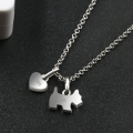 Sterling silver necklace featuring a zircon-studded dog pendant and polished onyx heart charm