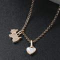 Sterling silver necklace featuring a zircon-studded dog pendant and polished onyx heart charm
