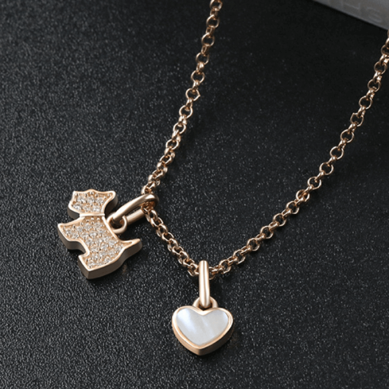 Sterling silver necklace featuring a zircon-studded dog pendant and polished onyx heart charm