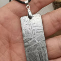 Silver tipped meteorite necklace with a meteorite pendant
