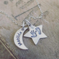 Moon & Star Necklace Lifestyle Image Moon and star personalised necklace shown in a lifestyle setting