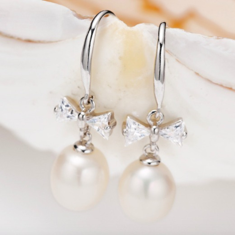 Freshwater Pearl Bow Earrings Freshwater pearl earrings with bows on sterling silver hooks