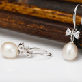 Freshwater Pearl Bow Earrings Freshwater pearl earrings with bows on sterling silver hooks