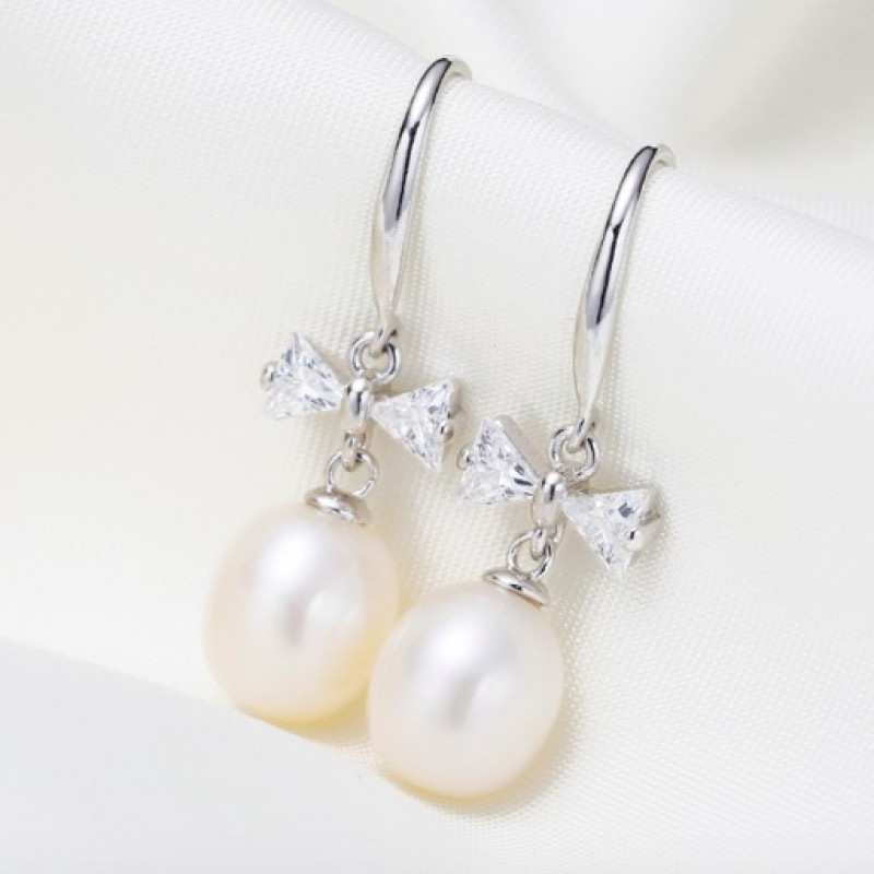 Freshwater Pearl Bow Earrings Freshwater pearl earrings with bows on sterling silver hooks