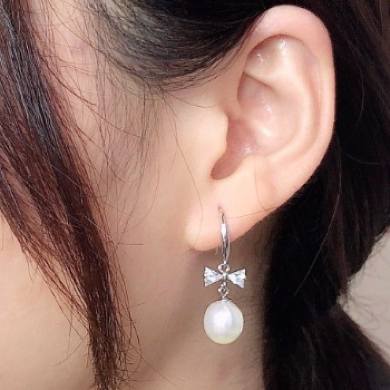 Freshwater Pearl Bow Earrings Freshwater pearl earrings with bows on sterling silver hooks