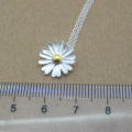 Dainty sunflower necklace with a matte-pattern pendant and yellow-gold-plated centre