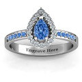 Pear shaped halo ring with a centre stone and prong-set shoulder accents