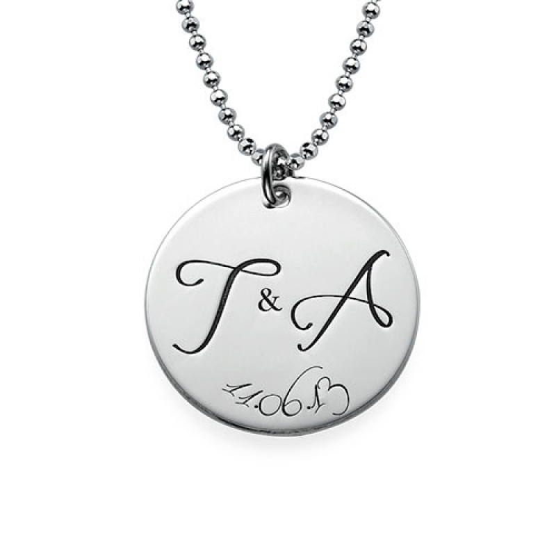 Engraved initial necklace with two initials and a special date on a round disc pendant