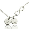 Custom infinity initial necklace with an infinity charm and initial disc