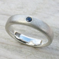 Men's black diamond ring with a plain band