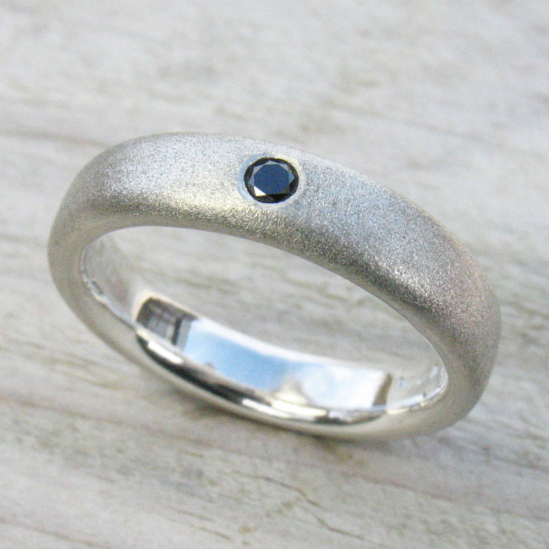 Men's black diamond ring with a plain band