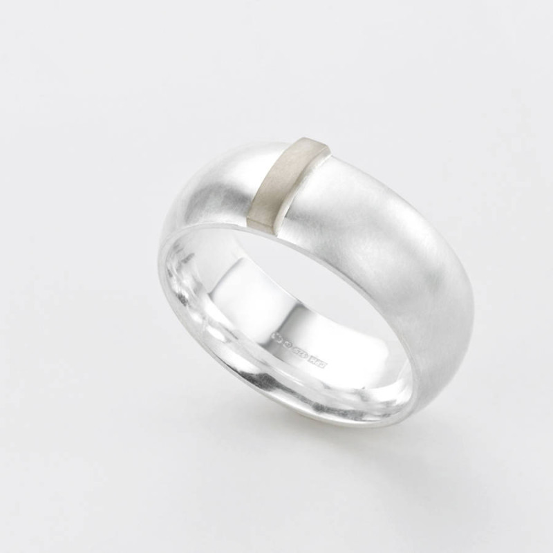 Linear Ring with a wide silver band and raised gold detail