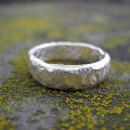 Rocky Outcrop Slim Ring with a rock-like textured outer surface