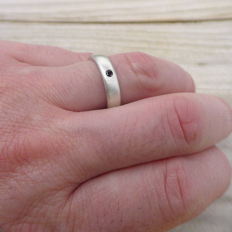 Men's black diamond ring detail view