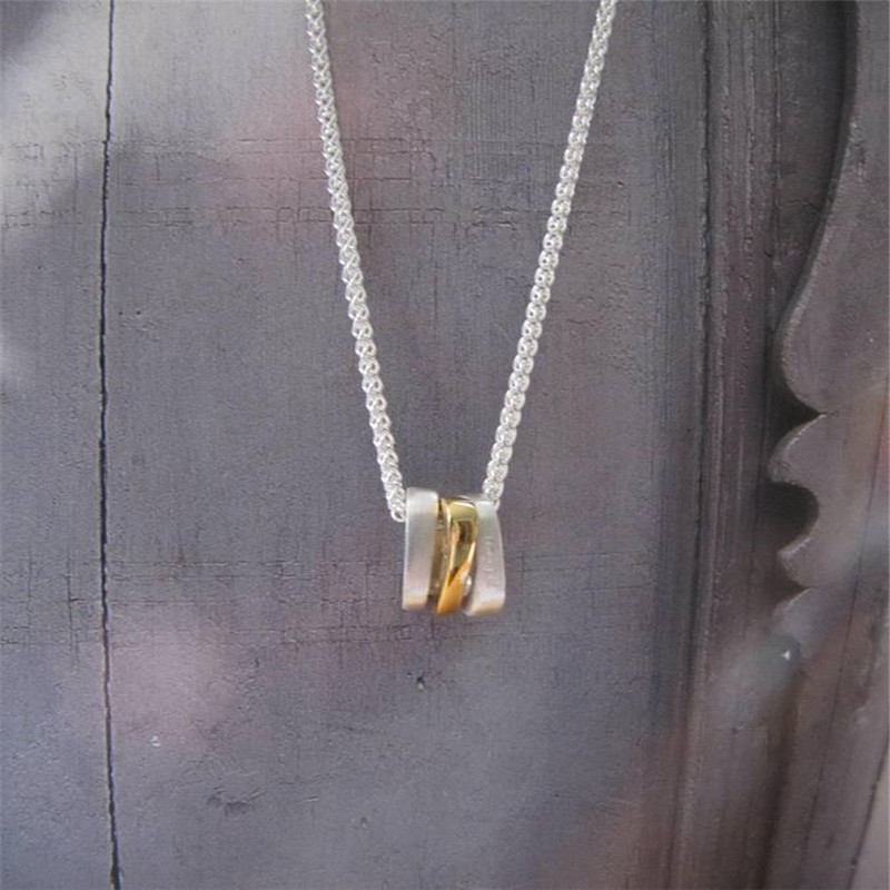 Silver Oval Necklace with Gold Silver oval necklace with three gold-plated oval rings