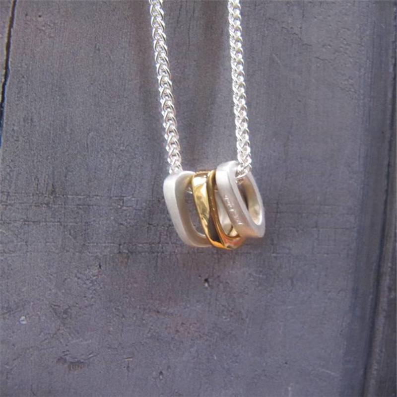 Silver Oval Necklace with Gold Silver oval necklace with three gold-plated oval rings