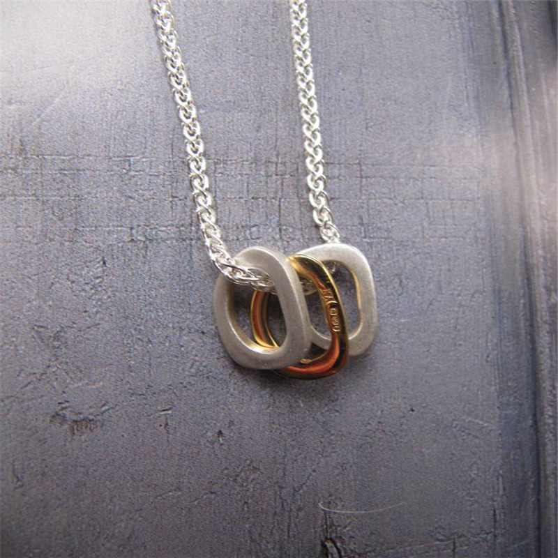 Silver Oval Necklace with Gold Silver oval necklace with three gold-plated oval rings