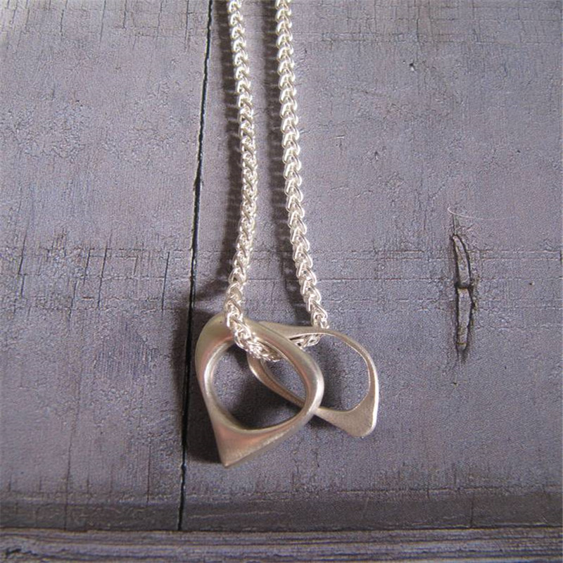 U And Me To Infinity Silver Oval Pendant Necklace Two silver oval pendants on a woven necklace chain