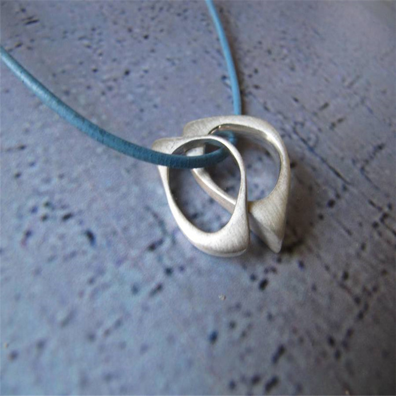 U & Me2 infinity pendants on leather necklace product image
